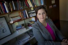 Mirya Holman sits in front of book shelf