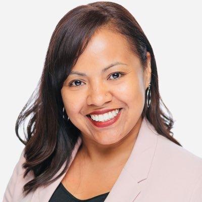 Ivy Cargile in light pink blazer in front of white background