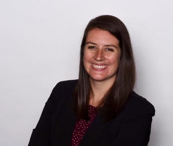 Kylee Britzman in a black blazer in front of a light gray background