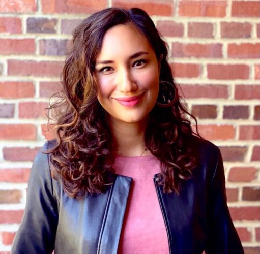 Margaret Brower in a black jacket in front of a brick wall