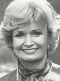 U.S. Ambassador Margaret Hecker, wearing a striped shirt and necklace